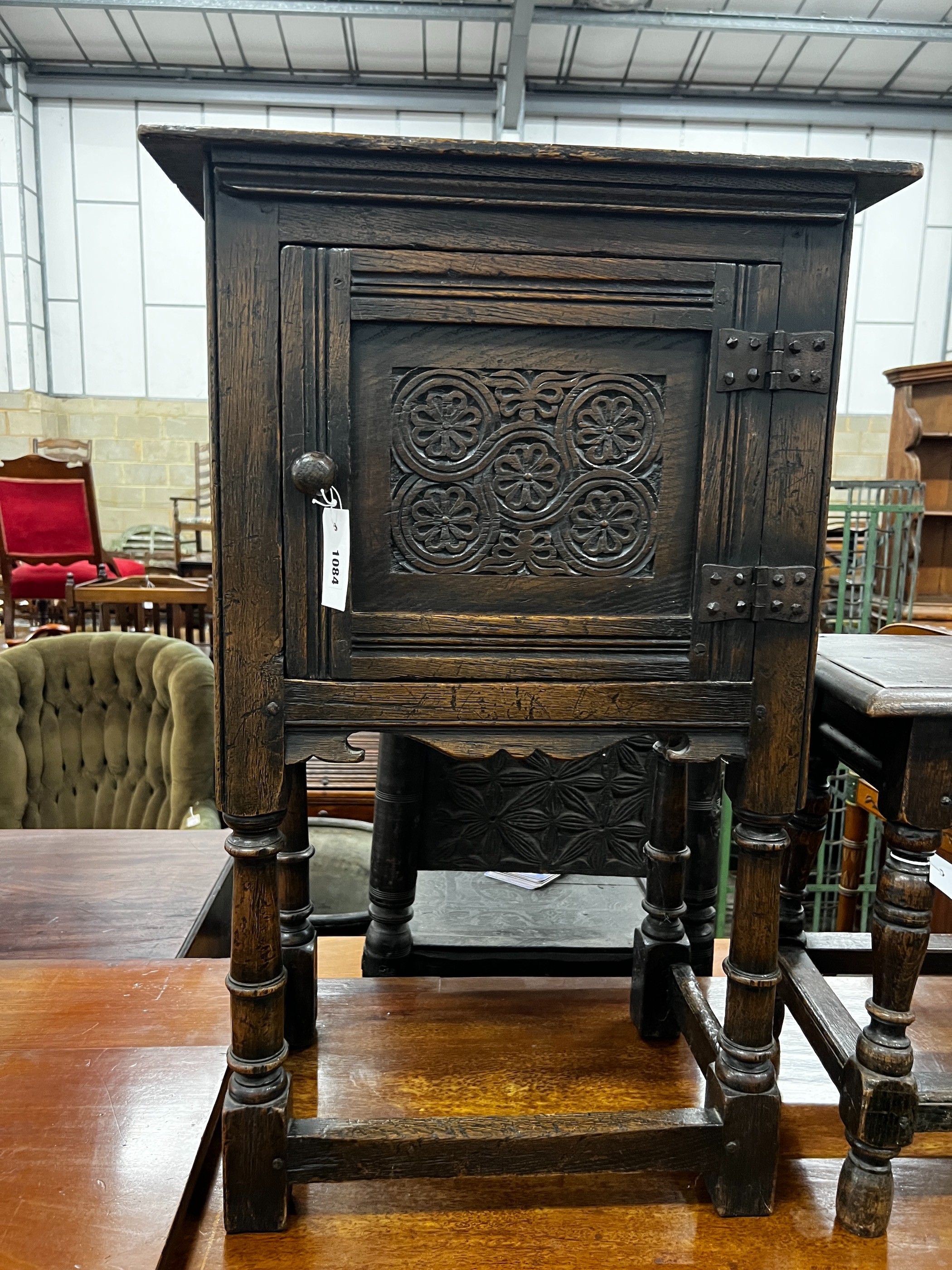 A small 17th century style carved oak side cabinet, width 53cm, depth 34cm, height 83cm